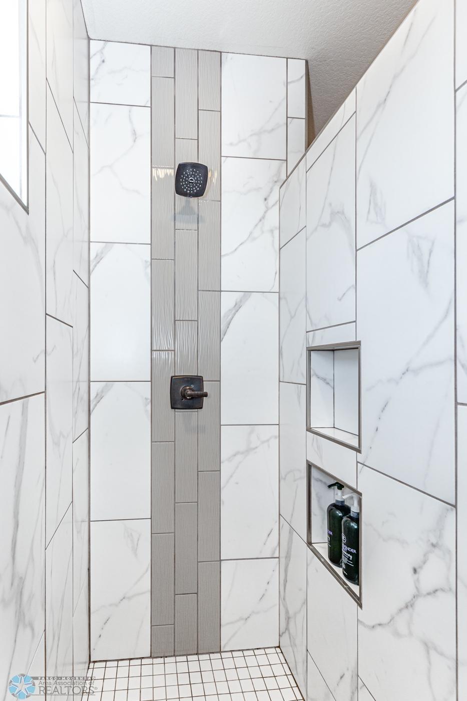 Primary Bathroom | tile shower w/built-in shelves
