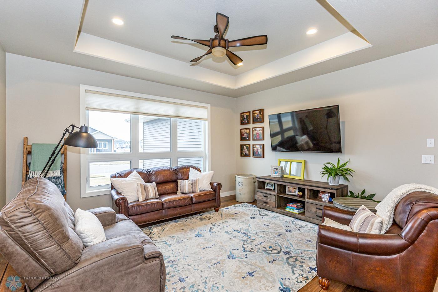 Living Room with ceiling detail and large windows