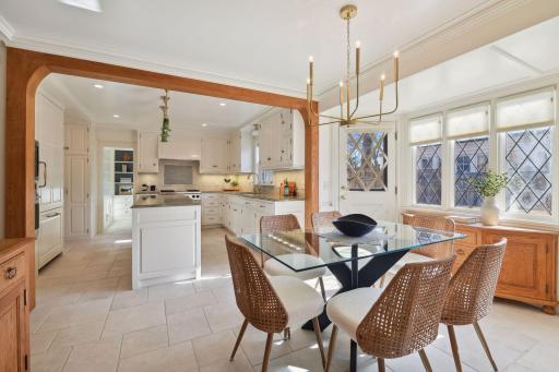 Informal dining space opens to delightful patio area on side yard for easy grilling