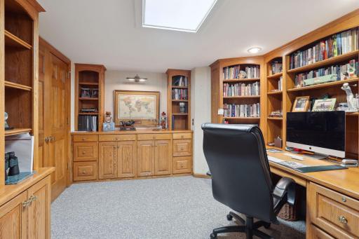 Double doors close off this lower level office space with impressive built-in's. Half bath outside office