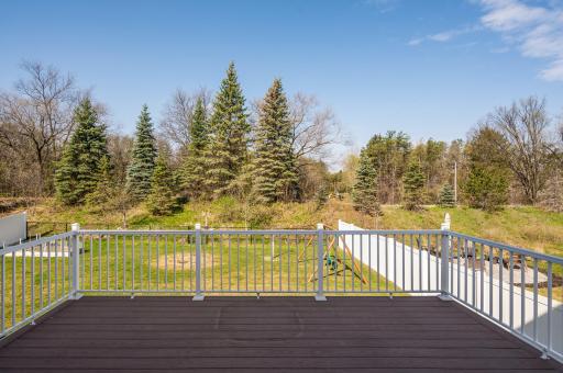 Views of backyard from deck! Tons of large mature evergreen trees line the entire backyard!
