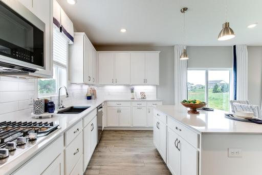 Ample cabinet and countertop space! Soft close doors and drawers + pull out recycle center are features included in this kitchen. *Photo of model home, same floor plan; colors and options may vary.