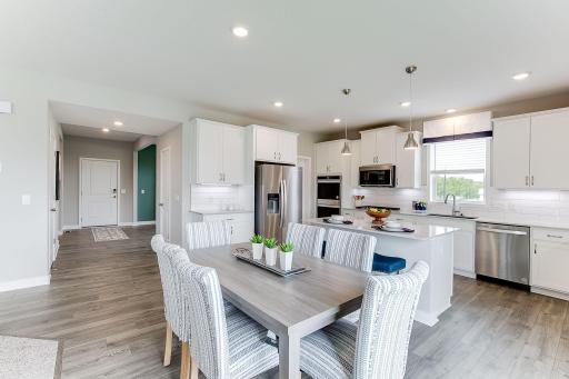The Signature kitchen boasts a double oven, gas cooktop, tiled backsplash and ample cabinet space. *Photo of model home, same floor plan; colors and options may vary.