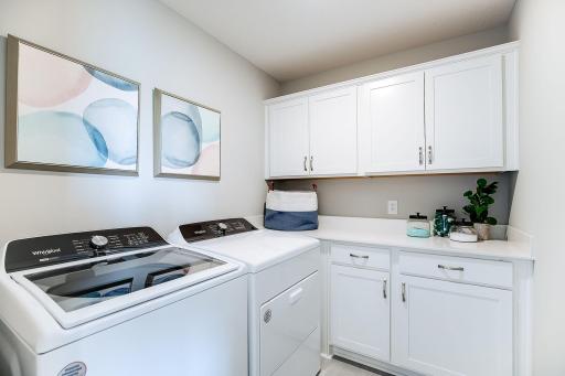 Upper-level laundry on the same level as 4 bedrooms for your convenience + built in cabinetry with quartz tops! Appliances not included. *Photo of model home, same floor plan; colors and options may vary.