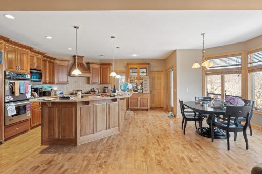 Delight in the gourmet kitchen equipped with stainless steel appliances, double wall oven, a generous center island with breakfast bar seating, and a walk-in pantry for added convenience.