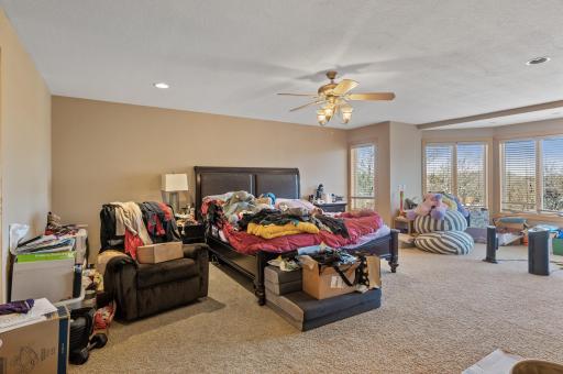 Retreat to the upper-level primary suite offering dual walk-in closets, a double-sided fireplace, and a lavish private bathroom.