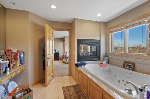 Alternate view of the private bathroom showcasing the double sided fireplace.