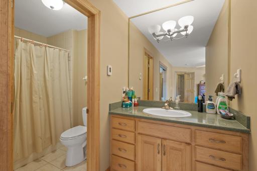 Full en suite bathroom with tub/shower combo, tile floors and separate water closet.