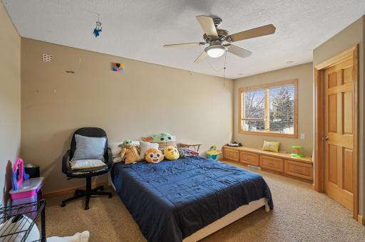 View of bedroom #3 sharing a jack-and-jill style bathroom, each boasting individual vanity rooms.