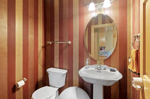 Completing the main level, you'll find a powder room for guests' comfort and convenience. Additionally, a spacious mudroom provides easy access to the laundry room, ensuring seamless organization of daily tasks.