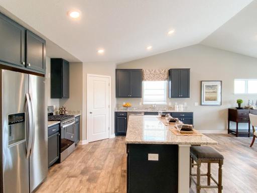 Stunning in every direction, the kitchen is also remarkably functional - leaving plenty of space for the family chef to maneuver and prepare that next meal. Photo of model, colors will vary
