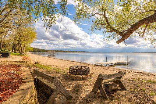95 feet of sandy lake frontage; imagine friends and family gathered here to share in the fun and beauty year round.