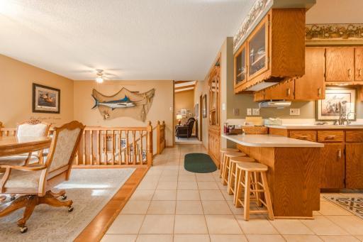 View of hallway to the upper 2 bedrooms, bathroom and the living room. Spacious gathering areas.