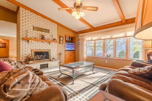 The Living room has wonderful site lines to Lake Minnewaska. A lovely wood burning fireplace and ceiling beams add an ambiance characteristic of lake home living.