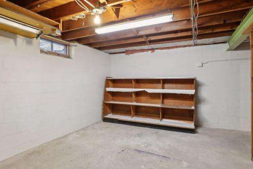 The large unfinished space in the basement has plenty of room for storage.