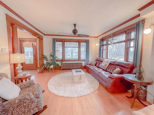 Living room features, stained glass windows, hardwood floors and original woodwork
