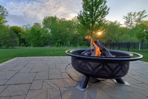 Piped natural gas feeds the fire pit on back yard patio - one could easily plumb for a gas line to include your gas grill on deck or patio.