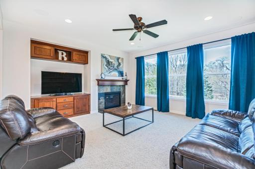 Family room with gas fireplace, appointed with a slate surround, built in entertainment station. Large picture windows overlooking the park-like, rear yard spaces.