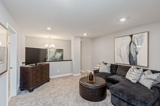 (Photo of decorated model, actual home's finishes may vary slightly) Relax, play and enjoy! This upper level loft is conveniently located near each of the bedrooms.