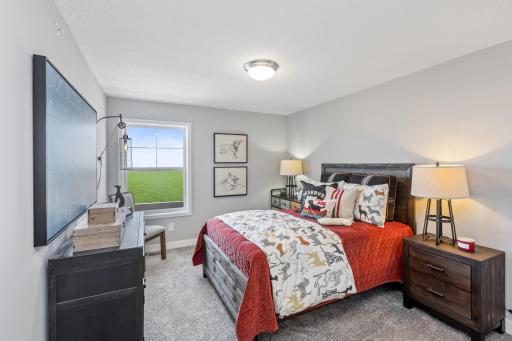 (Photo of decorated model, actual home's finishes may vary slightly) The second generously sized upper level secondary bedroom with a spacious closet