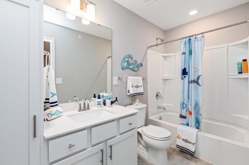 (Photo of decorated model, actual home's finishes may vary slightly) The home's secondary bath provides enough space for everyone to get ready during those busy mornings.