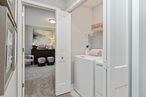 (Photo of decorated model, actual home's finishes may vary slightly) Centrally located on the upper level, along with the three bedrooms, this laundry room is sure to provide the ultimate convenience.
