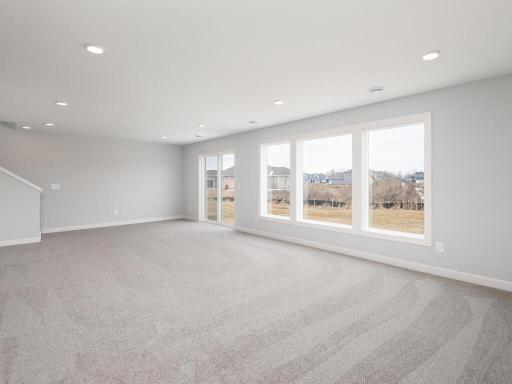 Walkout lower level has recessed lighting and large windows overlooking the Backyard.