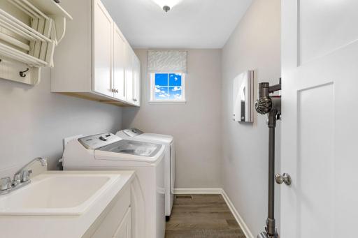 Convenient upper level laundry room with new washer and dryer. Upper storage cabinets and drying rack recently added.