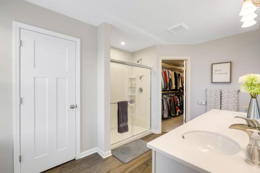 Spacious primary ensuite bathroom with dual vanity and walk-in shower and upgraded faucet.