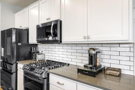 Quartz countertops, organic subway tile backsplash, upgraded smart appliances, enameled soft close cabinets and drawers, upgraded faucets, and shiplap accent added to the island, with two oversized pantries are a few of the perks in this home.