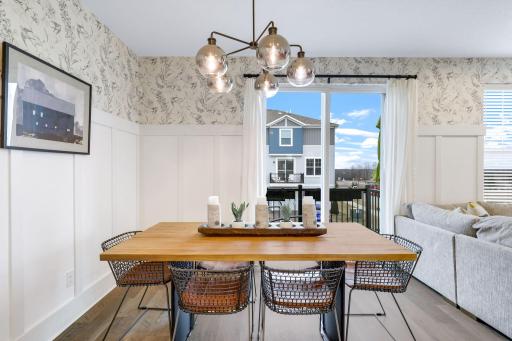 Beautiful dining room with board and batten and updated lighting, opens to a sun filled deck.