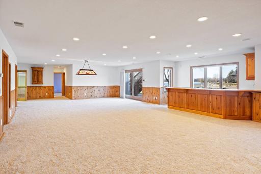 Family room with wood burning fireplace and wet bar