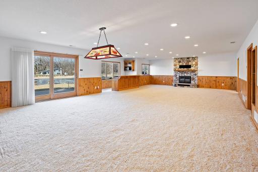 Family room with wood burning fireplace and wet bar