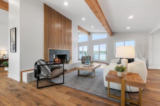 Hearth Room has see-through gas fireplace with modern alder surround and quartz raised hearth