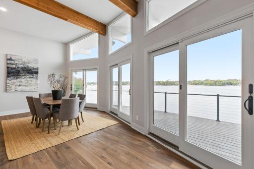 Full glass patio doors provide access to the massive deck and capture incredible views of Lower Prior Lake