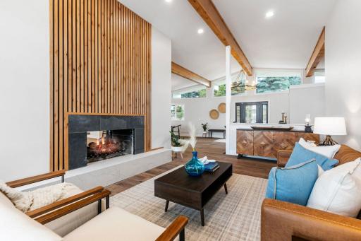 See-through gas fireplace with modern alder surround and quartz raised hearth