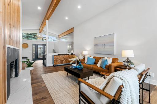 Vaulted ceilings with exposed beams wrapped in rustic alder