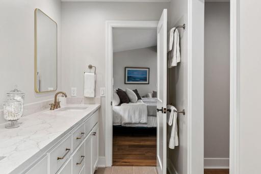 Seperate room for shower and stool with linen cabinet and pocket door access