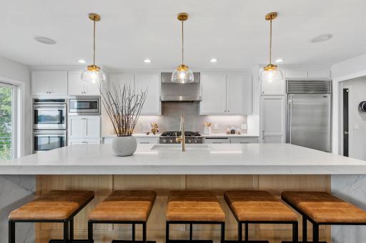 High-end appliances include Sub-Zero refrigerator, 36" Kucht Professional gas cooktop with stainless steel Vent-A-Hood, Wolf dual wall ovens, wine / beverage refrigerator, built-in microwave and Bosch dishwasher