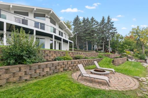Professional landscape boasts decorative concrete retaining walls and mature shrubs and perennials