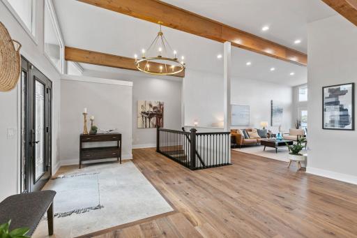 Vaulted ceilings with custom windows and exposed beams wrapped in rustic alder