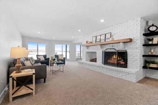 Gas fireplace with full brick surround and raised hearth in the Family Room