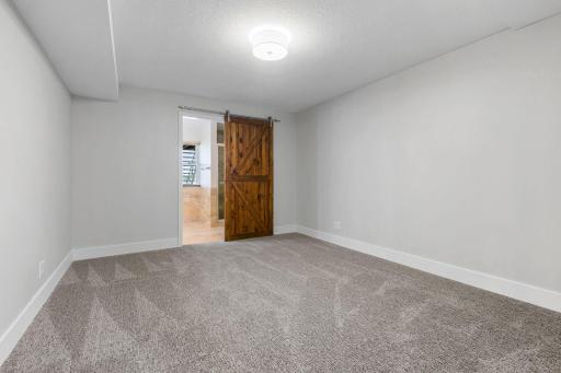 Bedroom 4 w/ barn door access to 3/4 Bathroom