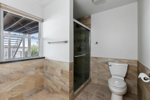 Custom shower features modern tile surround and semi-frameless glass doors