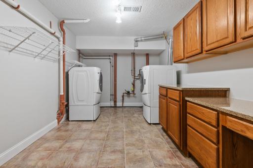 Laundry Room includes an abundance of cabinets with granite countertop and great storage capabilities!