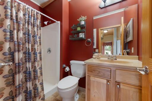 Convenient main floor bathroom offers walk-in shower and cute cabin vibes.
