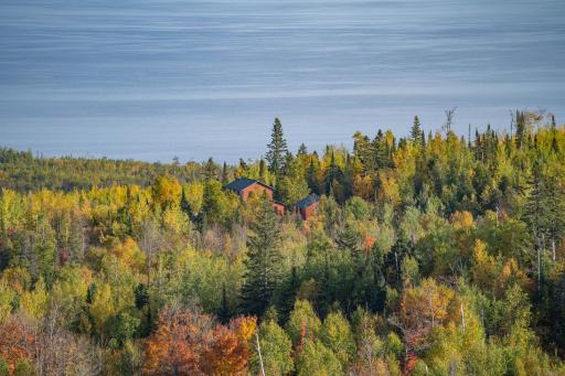 Cabin home is nestled in the woods with abundant views of Lake Superior that don't disappoint.