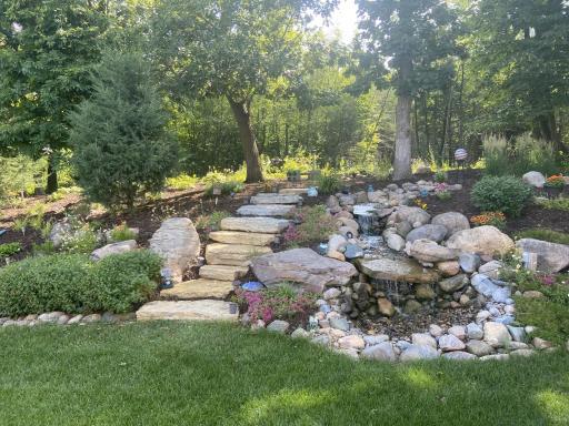 beautiful water feature that leads up to a firepit