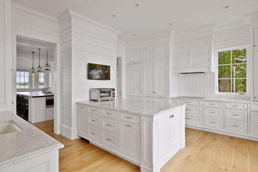 The primary kitchen and secondary catering kitchen have Carrara marble counters throughout...an entertainer’s dream!