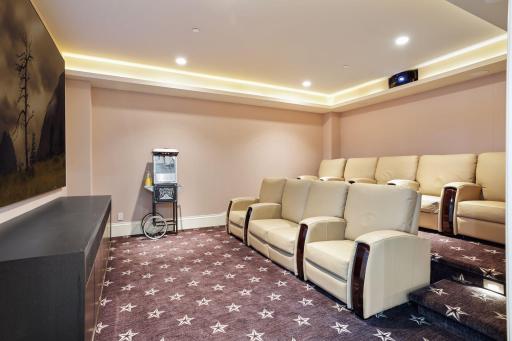 Enjoy the theatre room with comfortable seating for nine.